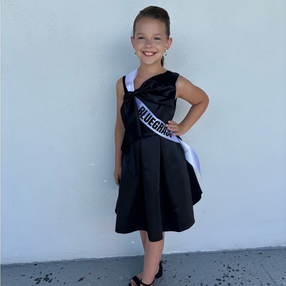 Black cocktail length girls dress.
